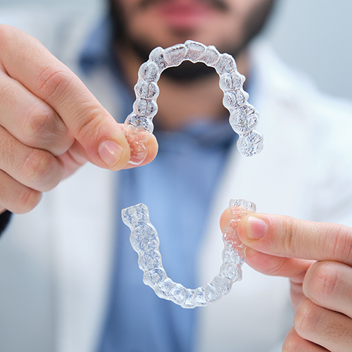 happy woman with braces after visiting legend dental and orthodontics austin georgetown tx